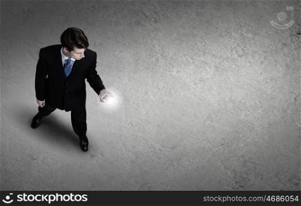 Man with mobile phone. Top view of young businessman using mobile phone