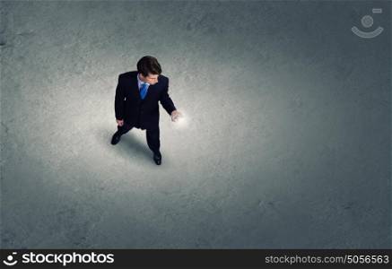 Man with mobile phone. Top view of young businessman using mobile phone