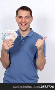 Man with money showing thumbs up