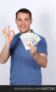 Man with money showing thumbs up