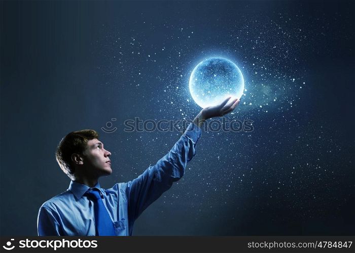 Man with moon. Young man in suit holding moon in palm
