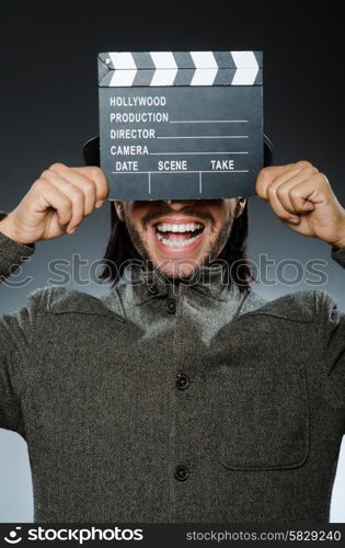 Man with movie clapperboard and hat