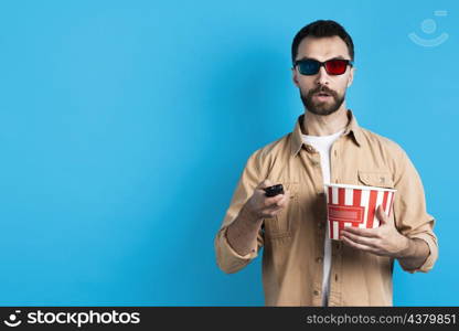 man with movie glasses pointing remote control