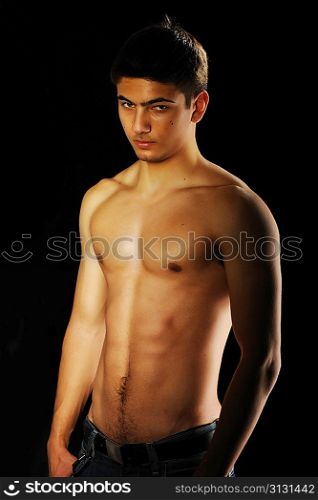Man with muscular torso over black