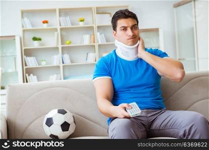 Man with neck injury watching football soccer at home