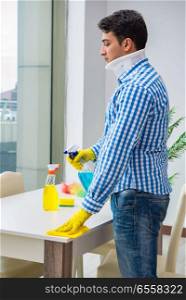Man with neck unjury cleaning house in housekeeping concept