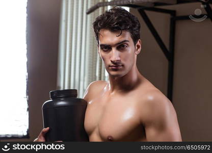 Man with nutrient supplements in sports gym