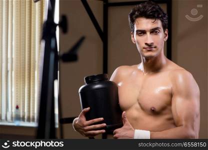 Man with nutrient supplements in sports gym
