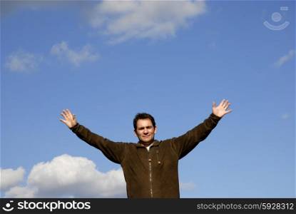 man with open arms and the blue sky