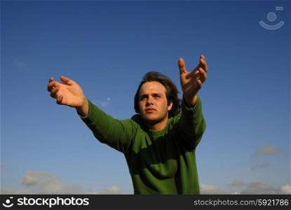 man with open arms with the sky as background