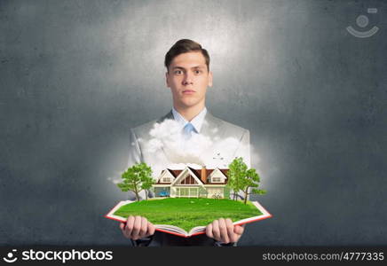 Man with opened book. Businessman holding opened book with green construction concept