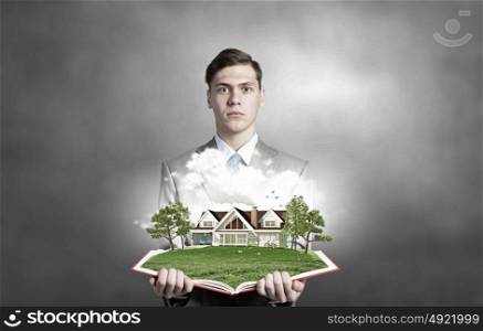 Man with opened book. Businessman holding opened book with green construction concept