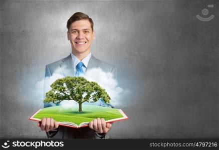 Man with opened book. Businessman open book with growing tree concept on pages