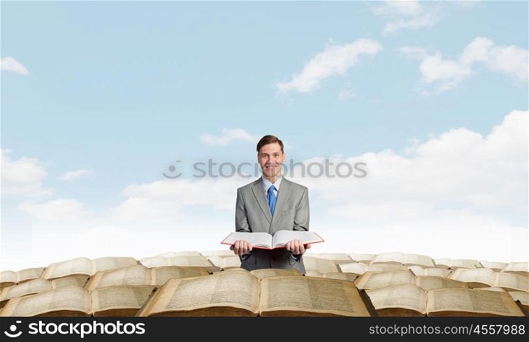 Man with opened book. Young businessman holding in hands blank opened book