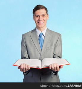 Man with opened book. Young businessman holding in hands blank opened book