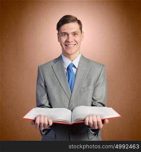 Man with opened book. Young businessman holding in hands blank opened book