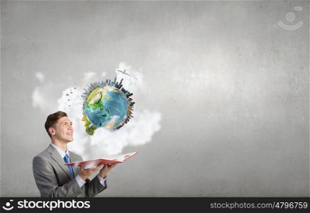 Man with opened book. Young businessman with opened book in hands. Elements of this image are furnished by NASA