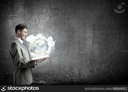 Man with opened book. Young businessman with opened book in hands. Elements of this image are furnished by NASA