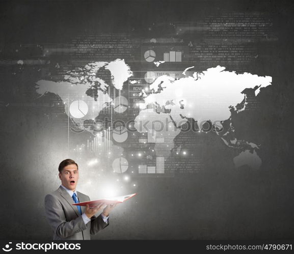 Man with opened book. Young businessman with opened book in hands and world map on pages