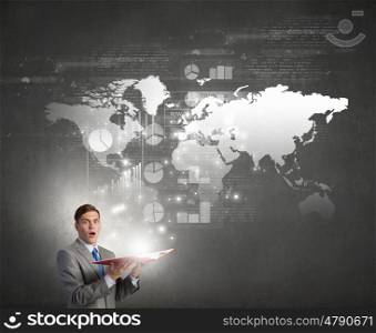 Man with opened book. Young businessman with opened book in hands and world map on pages