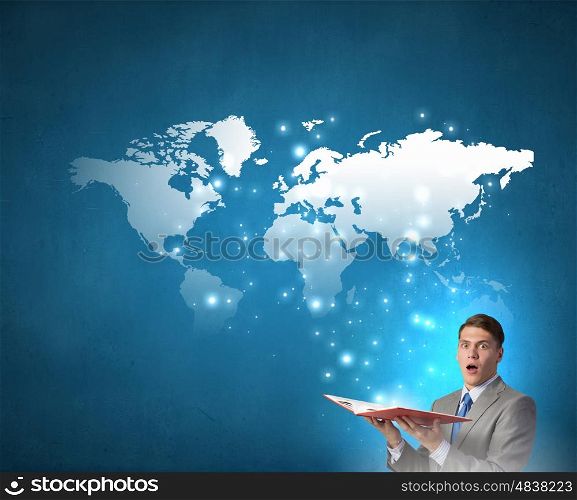 Man with opened book. Young businessman with opened book in hands and world map on pages
