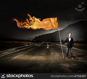 Man with orange waving flag. Student guy in casual with flag in hands