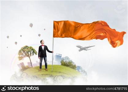 Man with orange waving flag. Student guy in casual with flag in hands