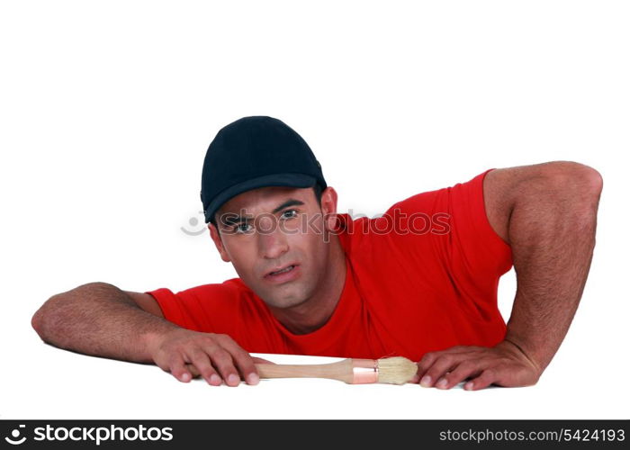 Man with paintbrush, studio shot