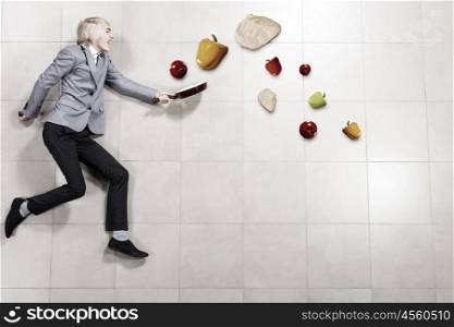 Man with pan. Young funny businessman running with pan in hand