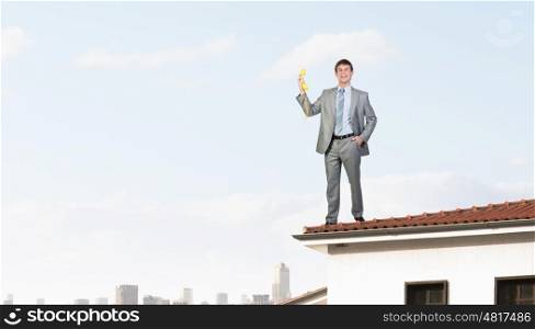 Man with phone receiver. Smiling businessman talking on yellow phone handset