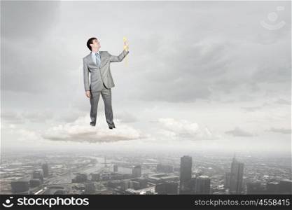 Man with phone receiver. Smiling businessman talking on yellow phone handset standing on cloud