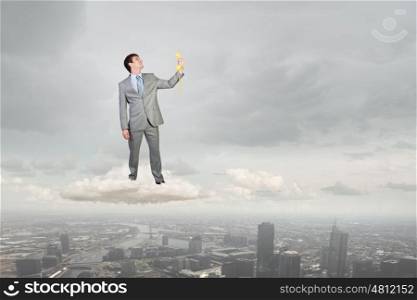 Man with phone receiver. Smiling businessman talking on yellow phone handset standing on cloud