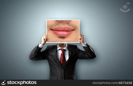 Man with photo. Unrecognizable businessman hiding face behind photo of mouth