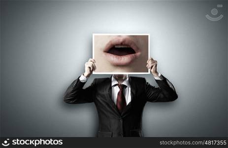 Man with photo. Unrecognizable businessman hiding face behind photo of mouth