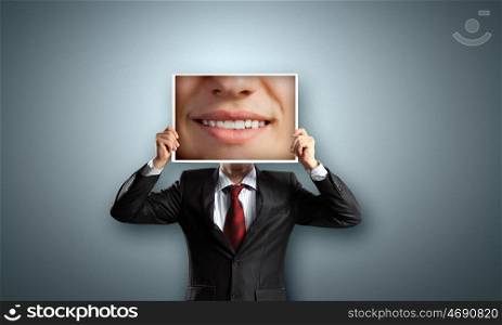 Man with photo. Unrecognizable businessman holding photo with smiling mouth