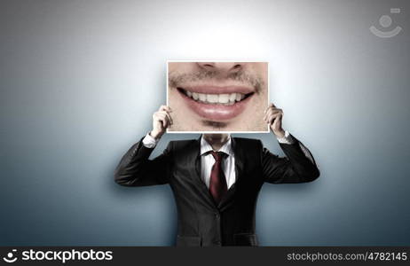 Man with photo. Unrecognizable businessman holding photo with smiling mouth