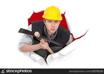 Man with pick-axe tearing through poster