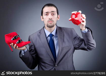 Man with piggybank on grey