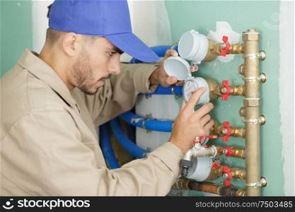man with pipes valves and water meters