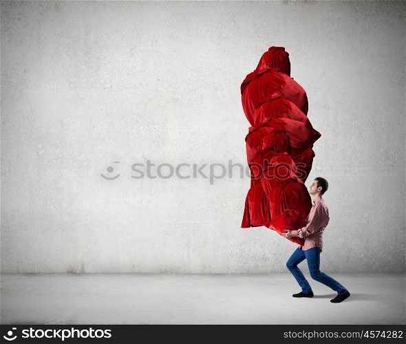 Man with red bag. Young man in casual carrying heavy red bag