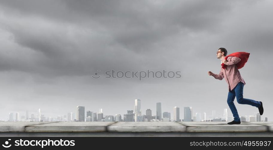 Man with red bag. Young man in casual carrying heavy red bag