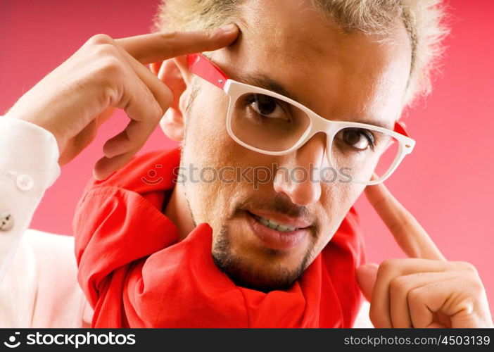 Man with red scarf against coloured background