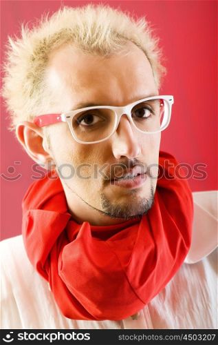 Man with red scarf against coloured background