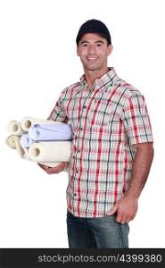 Man with rolls of wallpaper