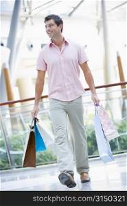 Man with shopping bags at a shopping mall