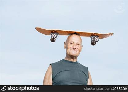 Man with skateboard on his head