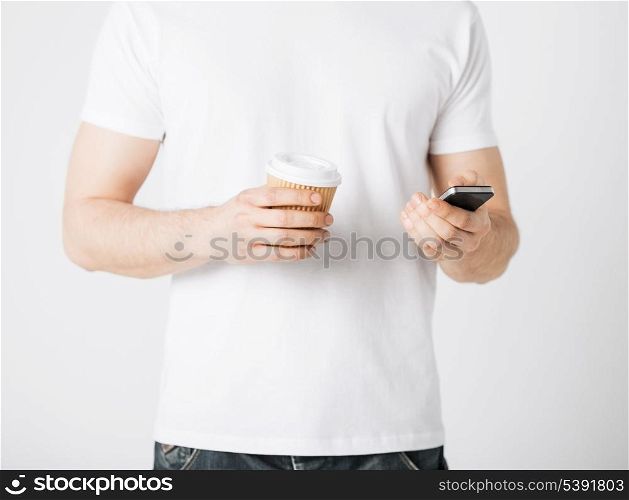 man with smartphone and take away coffee cup
