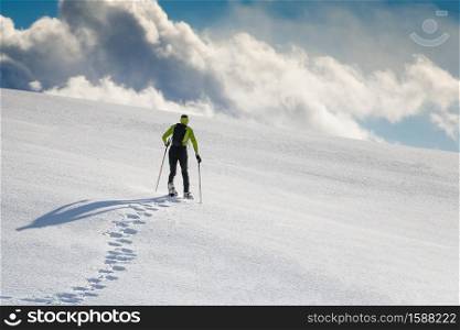 Man with snowshoes in a mountain