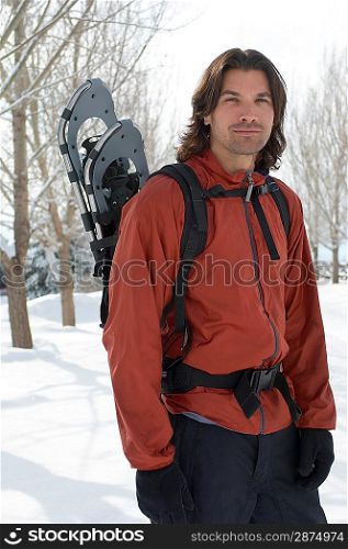 Man with Snowshoes Strapped on his Back