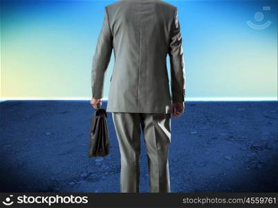Man with suitcase. Bottom view of businessman with suitcase in hand